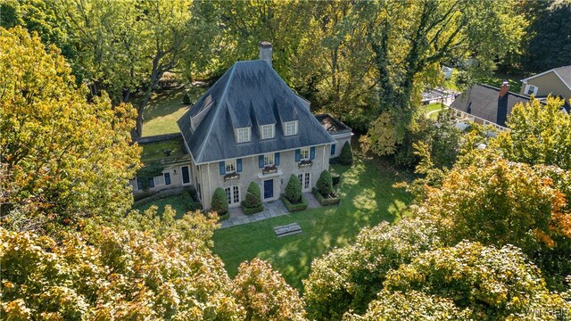 drone / aerial view with a wooded view
