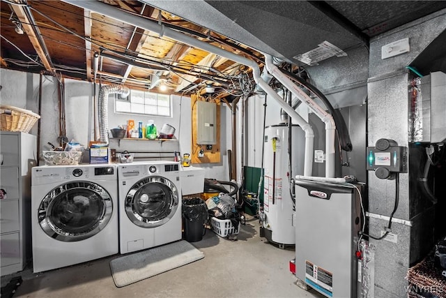 interior space featuring washer and dryer, gas water heater, heating unit, and laundry area