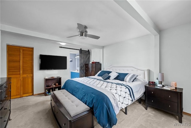 bedroom with light carpet, a ceiling fan, baseboards, and a barn door