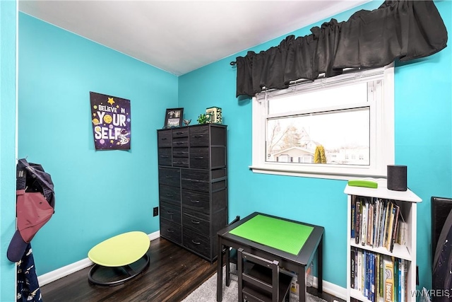 recreation room with baseboards and wood finished floors