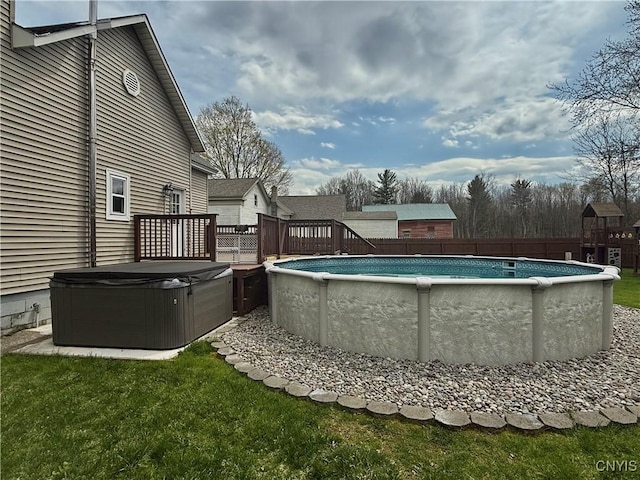view of swimming pool with a fenced in pool, fence, a yard, a hot tub, and a deck