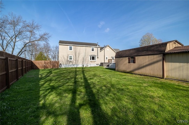 rear view of house featuring fence and a lawn
