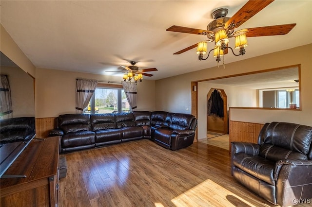 living area with a ceiling fan and wood finished floors