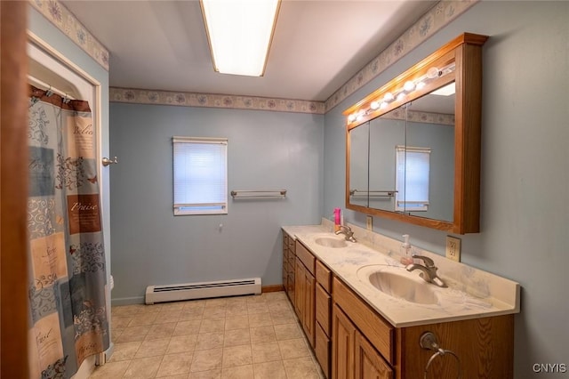 full bath featuring a baseboard heating unit, double vanity, baseboards, and a sink