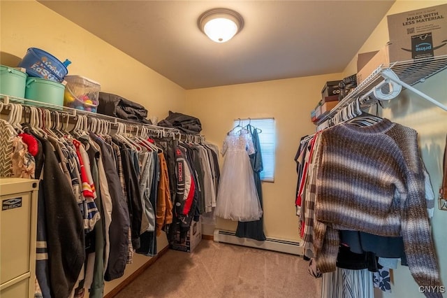 spacious closet featuring a baseboard heating unit and carpet flooring