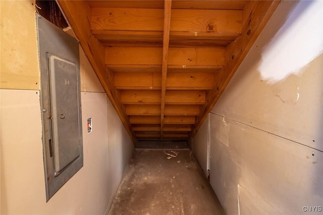 interior space with electric panel and unfinished concrete flooring