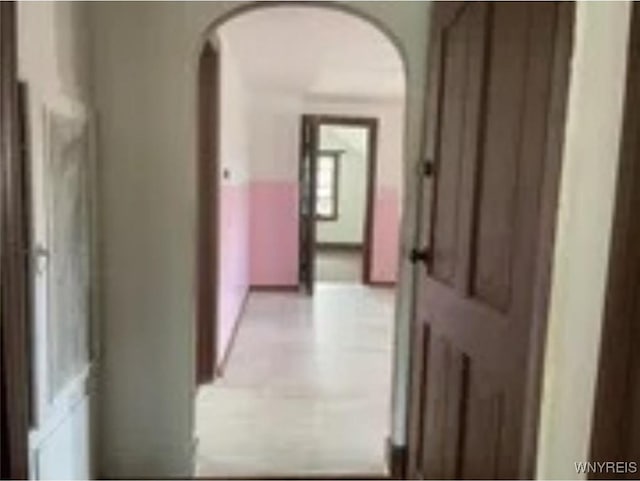 corridor featuring arched walkways