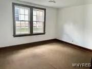 unfurnished room with baseboards