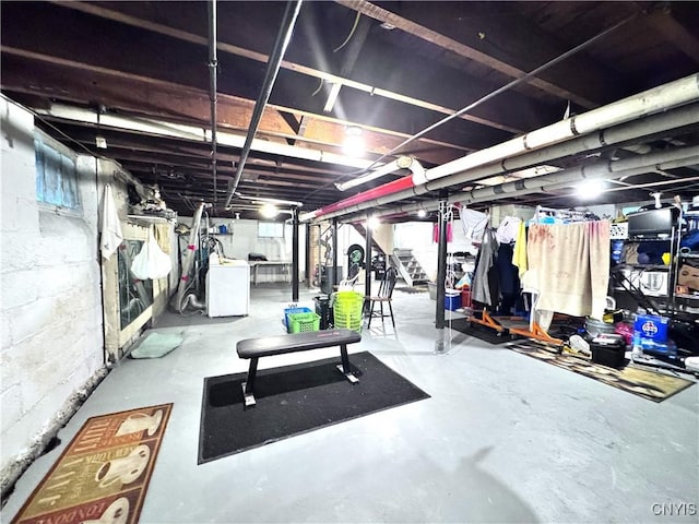 unfinished basement with washer / clothes dryer