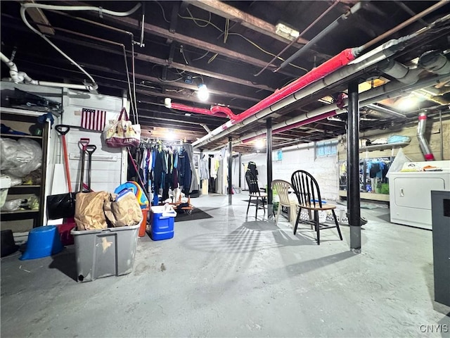 unfinished below grade area with washing machine and clothes dryer