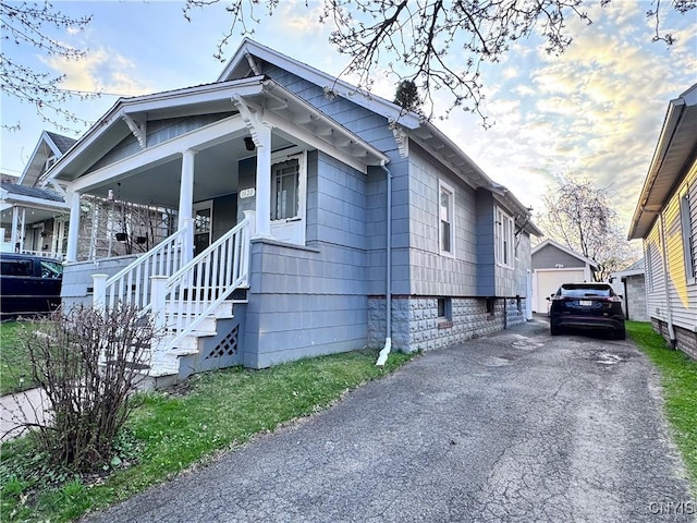 view of side of property featuring stairway, an outdoor structure, and a garage