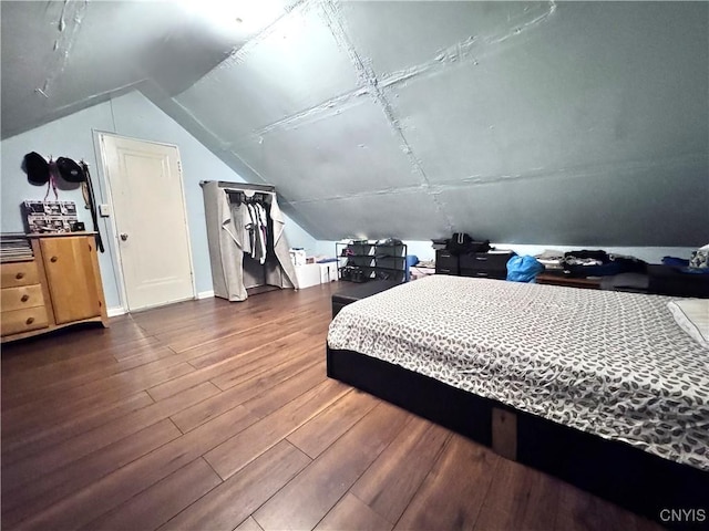 bedroom featuring lofted ceiling and wood finished floors