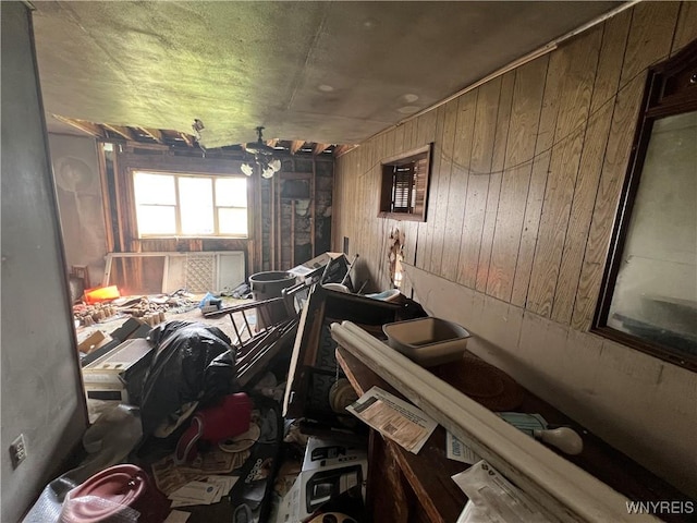 misc room featuring wood walls