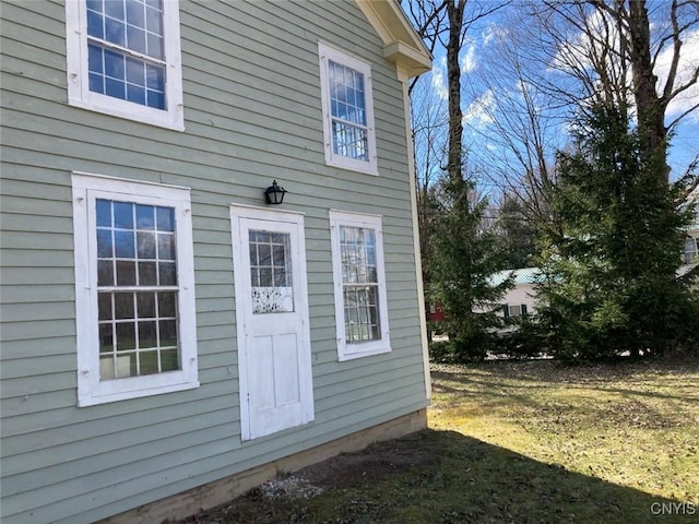 view of property exterior with a lawn