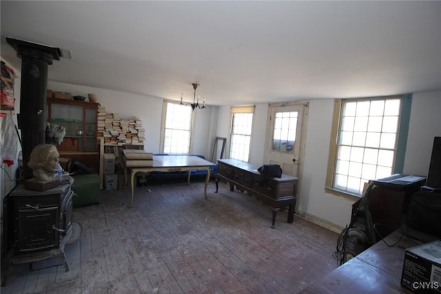 playroom featuring hardwood / wood-style flooring and a wood stove