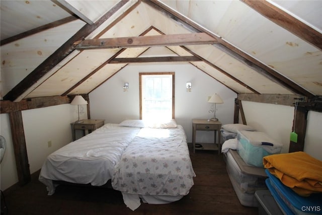 bedroom featuring vaulted ceiling with beams and hardwood / wood-style flooring
