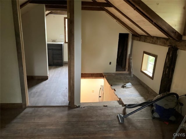 bonus room with vaulted ceiling with beams and a sink