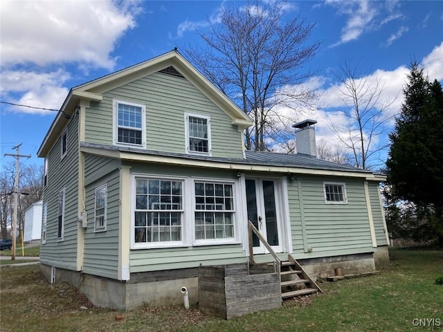 5081 Military Rd, Russia, NY 13431 - rear view of house with entry steps and a chimney