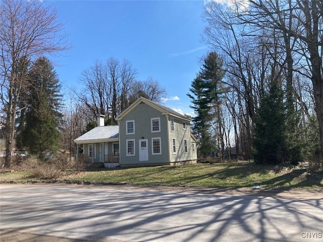 5081 Military Rd, Russia, NY 13431 - view of front of home featuring a chimney and a front lawn