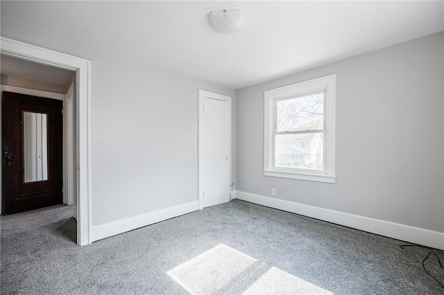 unfurnished bedroom with baseboards and carpet floors
