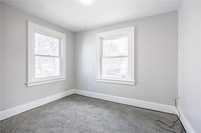 carpeted empty room with baseboards and a healthy amount of sunlight