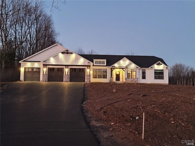 1M Longview Ter, Lysander, NY 13027 - modern farmhouse with asphalt driveway, a garage, and stone siding