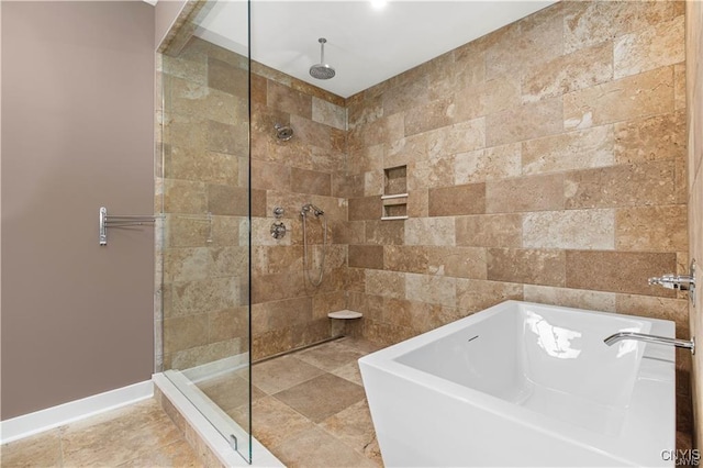 full bath with walk in shower, a bath, and baseboards