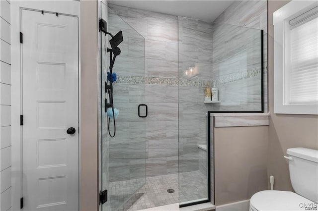 bathroom with toilet and a shower stall