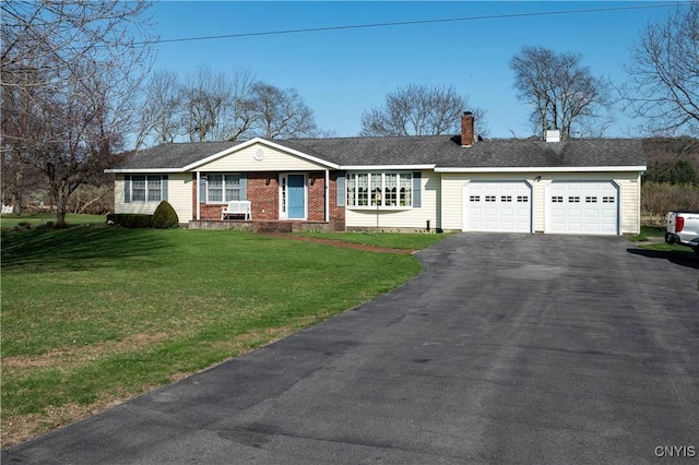 ranch-style home with aphalt driveway, a chimney, a front yard, an attached garage, and brick siding