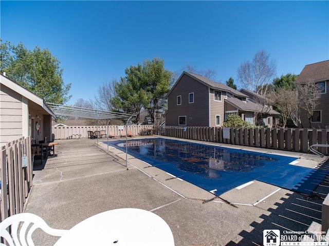 community pool featuring a patio and a fenced backyard