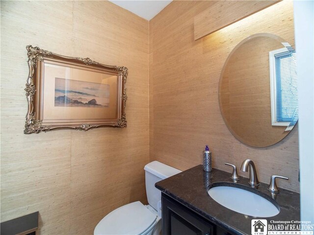 bathroom featuring toilet and vanity