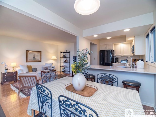 dining room featuring recessed lighting and light wood finished floors