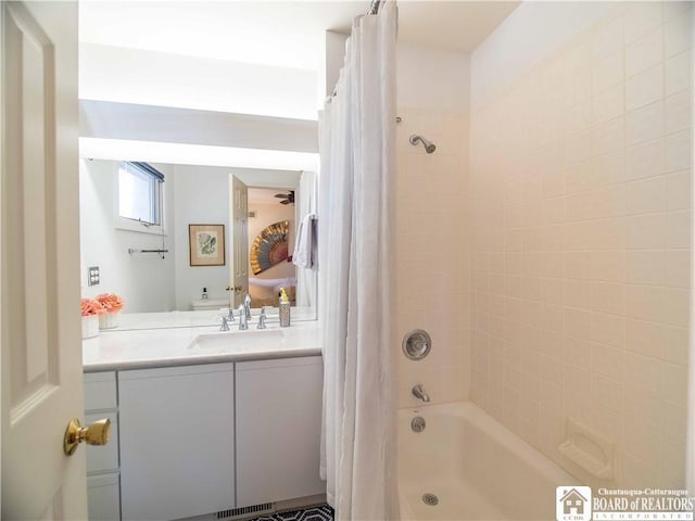 bathroom featuring shower / bath combo and vanity