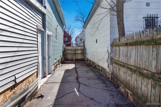view of property exterior with fence and a patio area