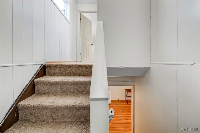 stairway featuring wood finished floors