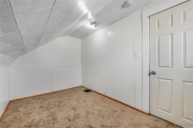 bonus room featuring visible vents, carpet, and lofted ceiling