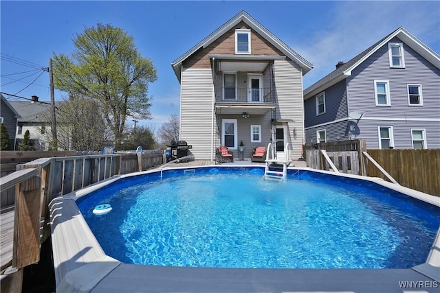 view of swimming pool featuring a fenced in pool, area for grilling, and a fenced backyard