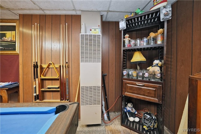 interior space with a paneled ceiling, billiards, and a heating unit