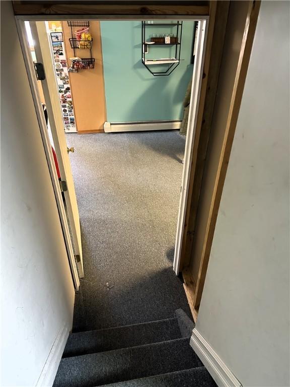 interior space featuring carpet flooring, baseboards, and a baseboard radiator