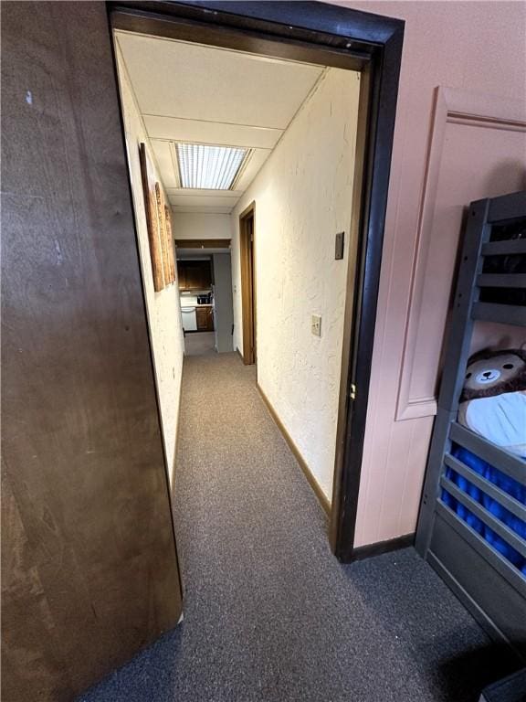 hallway featuring a textured wall
