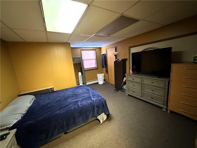 bedroom with a drop ceiling and a baseboard radiator