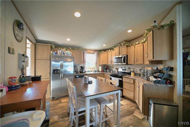 kitchen with light wood-style flooring, recessed lighting, light brown cabinetry, and appliances with stainless steel finishes