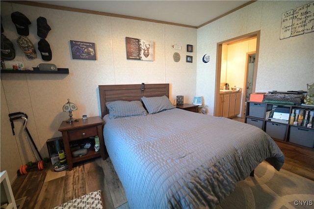 bedroom featuring wood finished floors and ornamental molding