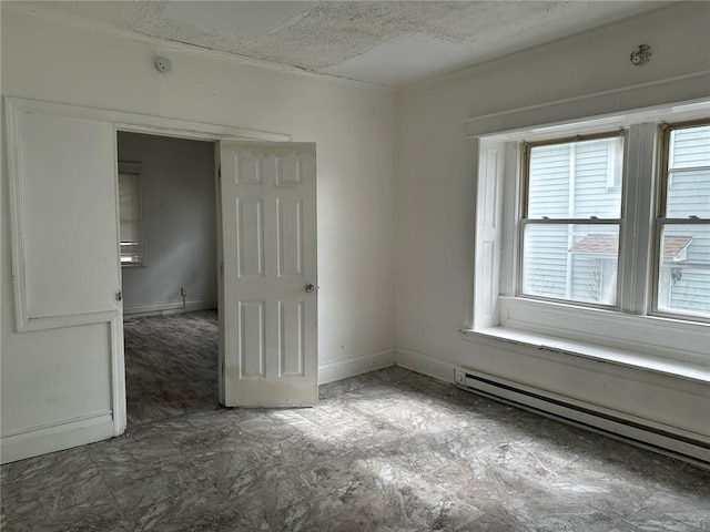 unfurnished room with baseboards and a baseboard radiator
