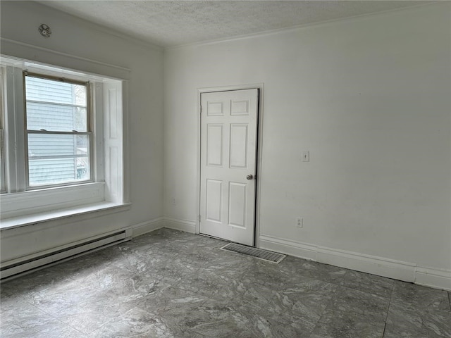 unfurnished room with baseboards, visible vents, a baseboard heating unit, and a textured ceiling