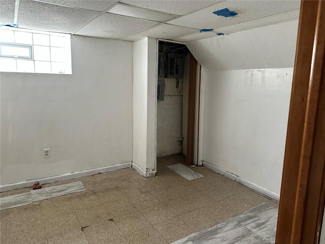 basement with tile patterned floors and baseboards