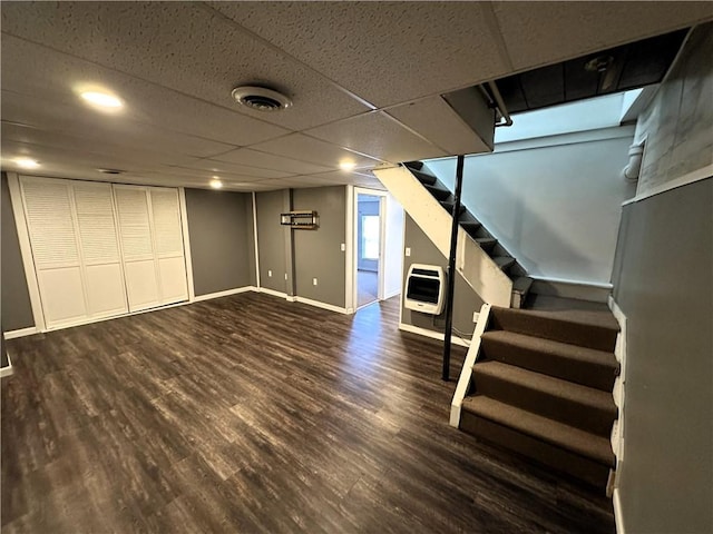 below grade area featuring recessed lighting, heating unit, wood finished floors, stairs, and baseboards