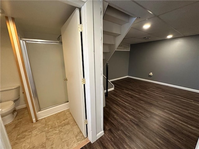 finished basement with baseboards, recessed lighting, and wood finished floors