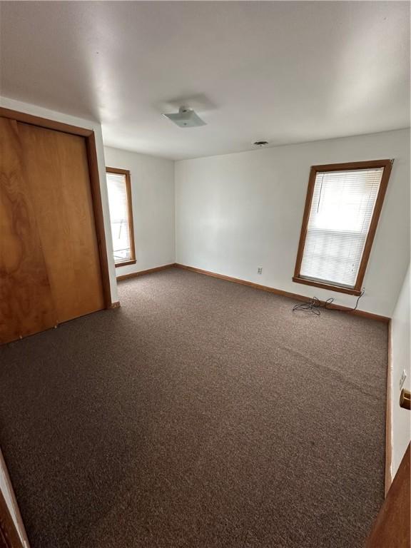 unfurnished bedroom with carpet floors and baseboards