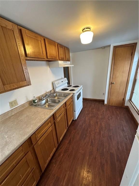 kitchen featuring a sink, light countertops, white electric range, dark wood-style flooring, and brown cabinetry